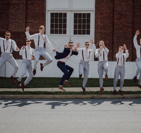 groomsmen and groom jumping for a photos hoot