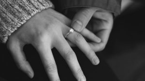 Woman's hand wearing moissanite engagement ring
