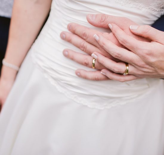 Couple wearing wedding ring holding hand