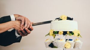 Couple cutting their wedding cake close up