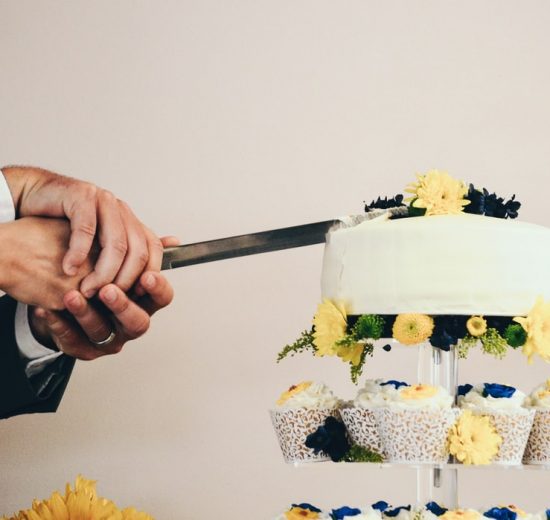 Couple cutting their wedding cake close up