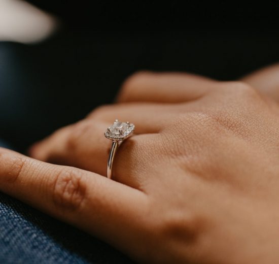 Square shape diamond engagement ring on girl's finger