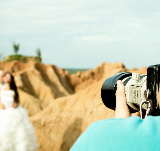 Photographer taking photo of bride and groom