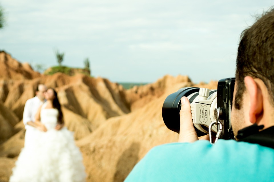 Photographer taking photo of bride and groom