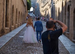 Bride and groom being photographed by a professional photographer