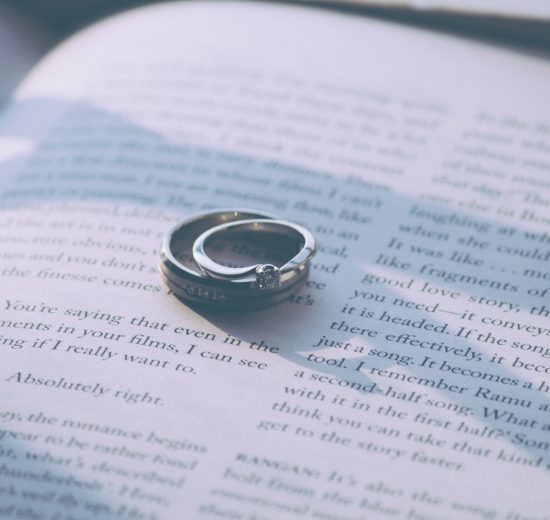 Sterling silver wedding rings on a open book page