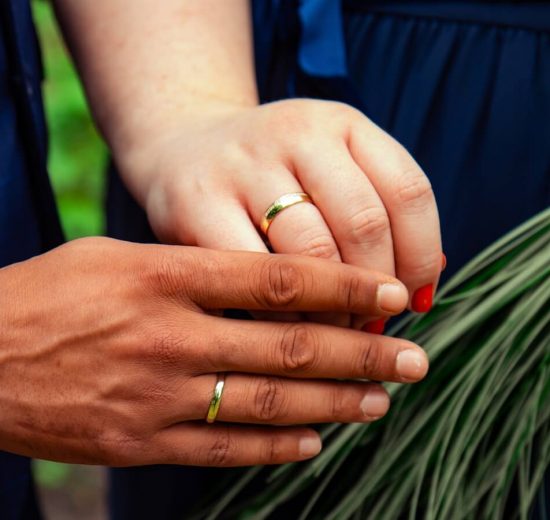 Couple wearing brass wedding rings