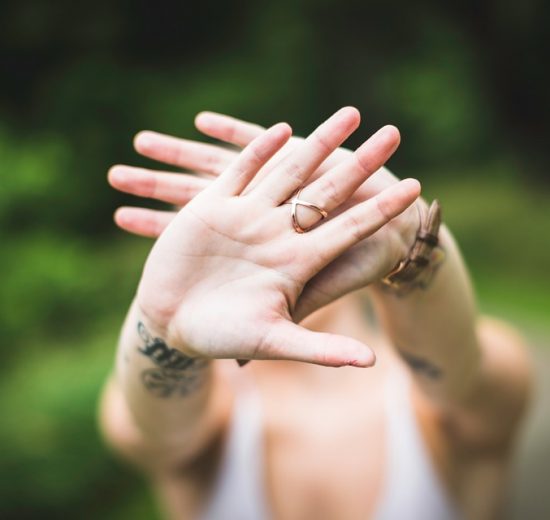 Girl wearing engagement ring on middle finger
