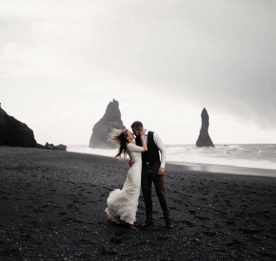 Bride and groom kissing at the beach