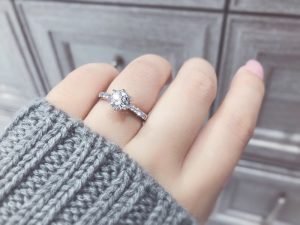 Girl wearing a gemstone that look like diamond in her engagement ring