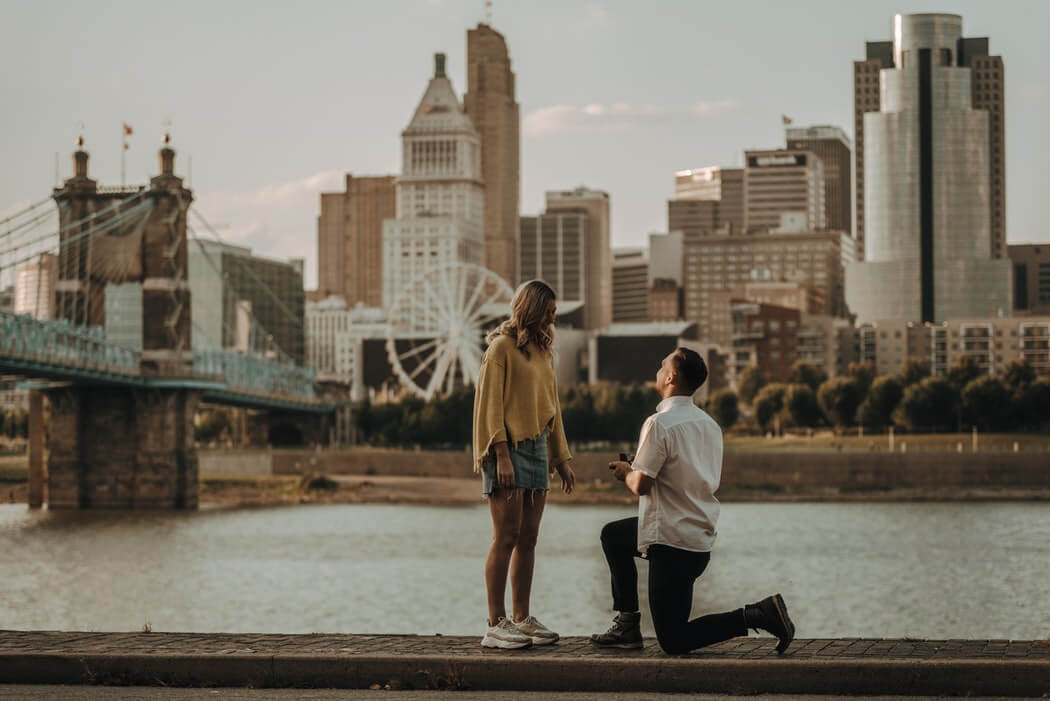 Man on his knees proposing in a river background