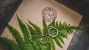 Platinum wedding rings on a leaf
