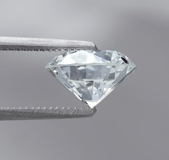 large diamond 2 carat held by tweezers