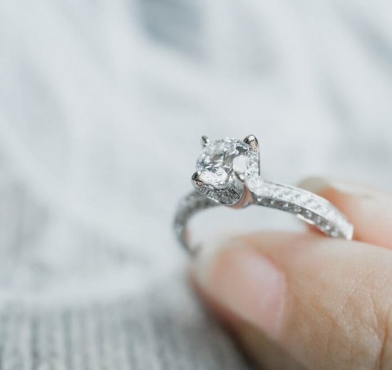 Holding a diamond ring with thick girdle
