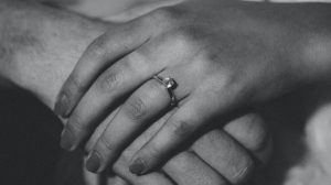 Girl wearing dainty engagement ring