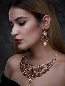 a woman wearing a gothic statement jewelry set