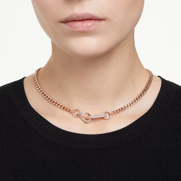 pave crystals and interlinking chain necklace on the woman's neck